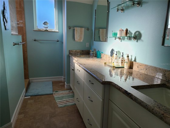 Master bath with dual sinks and large walk-in shower. - Single Family Home for sale at 1900 Illinois Ave, Englewood, FL 34224 - MLS Number is D6121965